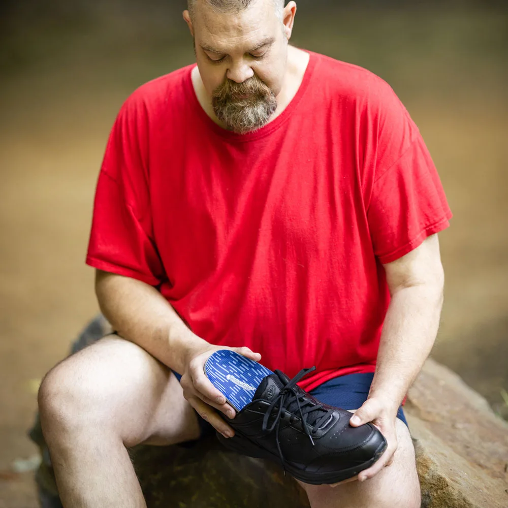 Placing PowerStep Pinnacle Wide Fit insoles into a shoe